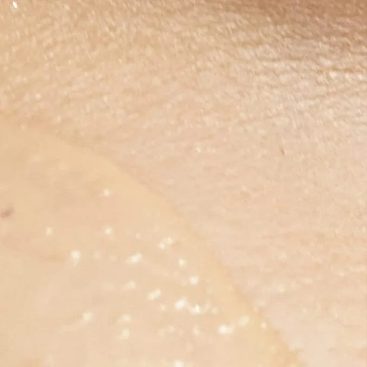 Close-up of the silky tinted lotion texture on skin